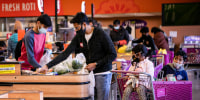 People shop at the Pioneer Cash & Carry in the Little India neighborhood in Artesia, Calif., on Dec. 28, 2021.